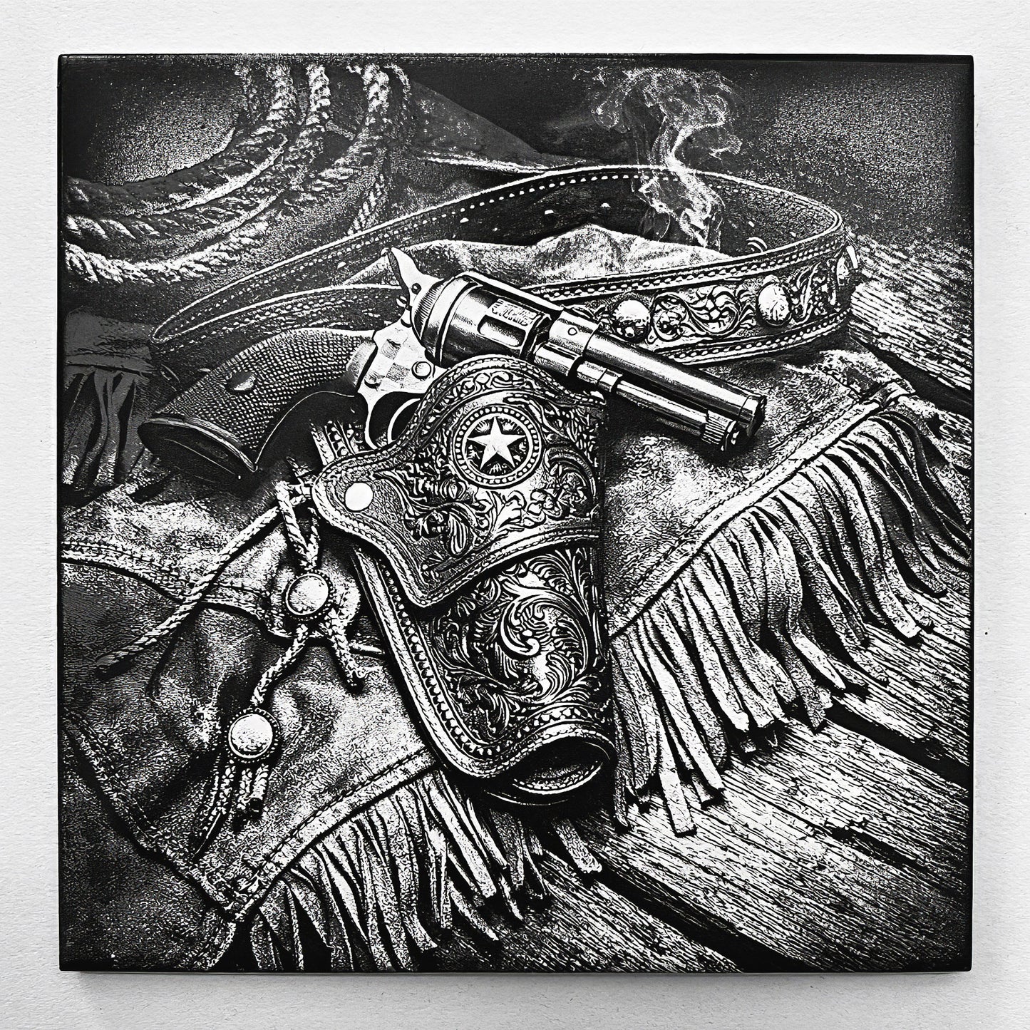 Engraved western revolver resting in an ornate leather holster with fringe and spurs, laser-etched on black ceramic tile.
