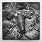 Engraved western revolver resting in an ornate leather holster with fringe and spurs, laser-etched on black ceramic tile.